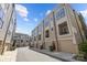 Exterior view of multiple townhouses on a street, each with a garage and balcony at 1617 Cannon View Ln, Charlotte, NC 28208