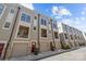 Townhouse exterior with garages, and balconies under large windows at 1617 Cannon View Ln, Charlotte, NC 28208