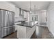 Modern kitchen features white cabinets, stainless steel appliances, a large island, and hardwood floors at 1617 Cannon View Ln, Charlotte, NC 28208
