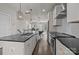 Modern kitchen with white cabinets, a spacious island, and an open layout flowing into the dining and living areas at 1617 Cannon View Ln, Charlotte, NC 28208