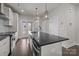 Modern kitchen featuring sleek white cabinetry, a large island with a sink, and stainless steel appliances at 1617 Cannon View Ln, Charlotte, NC 28208