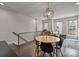 Spacious living area featuring hardwood floors, modern chandelier and a large area rug under the dining set at 1617 Cannon View Ln, Charlotte, NC 28208