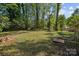 Large, flat backyard with mature trees, offering plenty of space at 1801 Weststone Dr, Charlotte, NC 28208