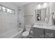 Bathroom with modern fixtures, tiled shower, and neutral color scheme at 1801 Weststone Dr, Charlotte, NC 28208
