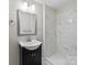 Updated bathroom features a modern vanity and a tiled shower at 1801 Weststone Dr, Charlotte, NC 28208