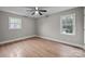 Bedroom with hardwood floors, windows, and neutral paint at 1801 Weststone Dr, Charlotte, NC 28208