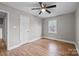 Bedroom showing hardwood floors, window, and ceiling fan at 1801 Weststone Dr, Charlotte, NC 28208