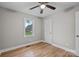 Bedroom featuring hardwood floors, neutral paint, window, and ceiling fan at 1801 Weststone Dr, Charlotte, NC 28208