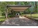 Carport and storage shed with a large concrete pad and corrugated awning at 1801 Weststone Dr, Charlotte, NC 28208