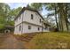 Exterior view of home showing brick foundation and partial driveway at 1801 Weststone Dr, Charlotte, NC 28208