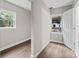 Hallway connecting rooms with hardwood floors and windows to exterior at 1801 Weststone Dr, Charlotte, NC 28208