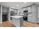 Modern kitchen with stainless steel appliances, stone countertops, and a center island at 1801 Weststone Dr, Charlotte, NC 28208