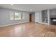 Bright living room featuring wood floors, large window, and staircase access at 1801 Weststone Dr, Charlotte, NC 28208