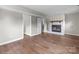 Open-concept living room boasts a stone fireplace and hardwood floors at 1801 Weststone Dr, Charlotte, NC 28208