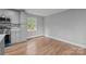Bright living room featuring hardwood floors and natural light from the window at 1801 Weststone Dr, Charlotte, NC 28208
