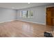 Bright living room featuring wood floors and large window at 1801 Weststone Dr, Charlotte, NC 28208