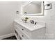 Bright bathroom boasts double vanity with black fixtures, a lighted mirror, and crisp white walls at 1812 Lot 2 Anderson St, Charlotte, NC 28205
