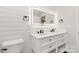 Chic bathroom features a dual vanity, lighted mirror, shiplap walls, and black fixtures at 1812 Lot 2 Anderson St, Charlotte, NC 28205