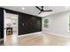 Sunlit bedroom with decorative black accent wall, ceiling fan, light floors, and neutral paint at 1812 Lot 2 Anderson St, Charlotte, NC 28205