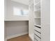 Bright walk-in closet with built-in shelving, cabinets and frosted window for privacy at 1812 Lot 2 Anderson St, Charlotte, NC 28205