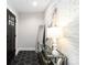Stylish entryway features hexagon tile flooring, a decorative mirror, and a sleek console table against a brick wall at 1812 Lot 2 Anderson St, Charlotte, NC 28205