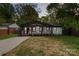 Charming bungalow with a covered porch, black trim, and freshly painted white brick at 1812 Lot 2 Anderson St, Charlotte, NC 28205