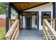 Inviting porch with stylish black trim, wood ceiling, and natural wood steps at 1812 Lot 2 Anderson St, Charlotte, NC 28205