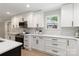Bright kitchen features white cabinets, black hardware, stainless appliances and ample counter space at 1812 Lot 2 Anderson St, Charlotte, NC 28205