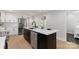 Modern kitchen features an island, stainless appliances, white cabinets, and light wood floors at 1812 Lot 2 Anderson St, Charlotte, NC 28205