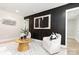 Modern living room showcases a black accent wall, contemporary art, stylish seating, and a geometric area rug at 1812 Lot 2 Anderson St, Charlotte, NC 28205