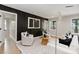 Modern living room with a black accent wall, contemporary art, stylish seating, and a patterned area rug at 1812 Lot 2 Anderson St, Charlotte, NC 28205