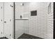 Shower features black fixtures, glass doors, and white subway tile with shampoo niche at 1812 Lot 2 Anderson St, Charlotte, NC 28205