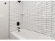 Crisp shower features black fixtures and white subway tiles with a built-in shampoo niche at 1812 Lot 2 Anderson St, Charlotte, NC 28205