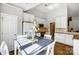 Sunlit dining area with white cabinets and modern appliances, perfect for Gathering meals at 2020 Makin Dr, Indian Trail, NC 28079