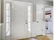 Bright foyer features a front door with sidelights, wood flooring, and white trim at 2020 Makin Dr, Indian Trail, NC 28079