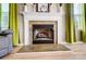 Cozy fireplace with decorative mantel and tile surround, complemented by bright green curtains at 2020 Makin Dr, Indian Trail, NC 28079