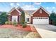 Charming brick home with well-manicured landscaping and an attached two-car garage at 2020 Makin Dr, Indian Trail, NC 28079