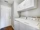 A laundry room boasts storage cabinets and a washing machine and dryer at 2020 Makin Dr, Indian Trail, NC 28079