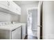 The laundry room features storage cabinets and a washer and dryer at 2020 Makin Dr, Indian Trail, NC 28079