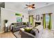 Inviting living room features a ceiling fan, fireplace, plush sofas, and lots of natural light at 2020 Makin Dr, Indian Trail, NC 28079