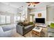 Spacious living area with hardwood floors, ceiling fan, and open floor plan to kitchen at 2020 Makin Dr, Indian Trail, NC 28079