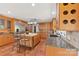 Bright kitchen boasts custom cabinets, an island with seating, and stainless steel appliances at 21 Hollyberry Woods, Lake Wylie, SC 29710