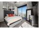 A city view bedroom with a large window, carpet, and a gray upholstered bed at 210 N Church St # 1307, Charlotte, NC 28202