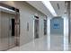Elevator lobby featuring multiple mirrored elevator doors and a sleek modern design for sophisticated transport at 210 N Church St # 1307, Charlotte, NC 28202