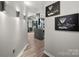 Hallway featuring modern lighting fixtures and decorative artwork creating an inviting entrance at 210 N Church St # 1307, Charlotte, NC 28202