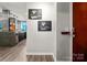 Condo hallway with artwork leading into the kitchen area, showcasing the modern design at 210 N Church St # 1307, Charlotte, NC 28202