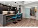 Modern kitchen featuring a waterfall island with seating, sleek cabinetry, and pendant lighting at 210 N Church St # 1307, Charlotte, NC 28202