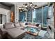 Comfortable living room with city views, a large sectional couch, and a glass coffee table at 210 N Church St # 1307, Charlotte, NC 28202