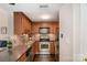 Galley kitchen features stainless steel appliances, wood cabinets and subway tile backsplash at 211 Heritage Blvd # 309, Fort Mill, SC 29715