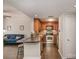 Open-concept living space features luxury vinyl plank flooring, a kitchen, and an adjacent living room at 211 Heritage Blvd # 309, Fort Mill, SC 29715